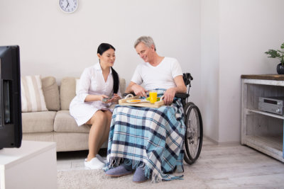 a nurse serving food to the elderly