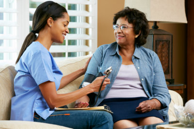 an elderly and a caretaker talking