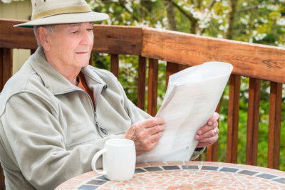 an elderly reading the news