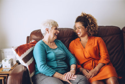 an old lady and a woman smiling at each other