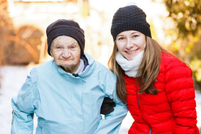 a woman and and old lady looking at the camera