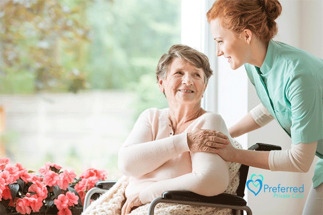 an elderly looking at a nurse smiling