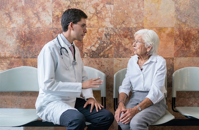 a doctor talking to an elderly