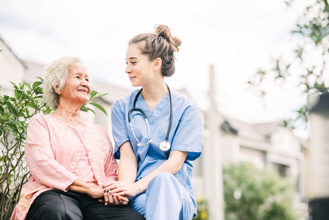 a woman and an elderly outside the house smiling