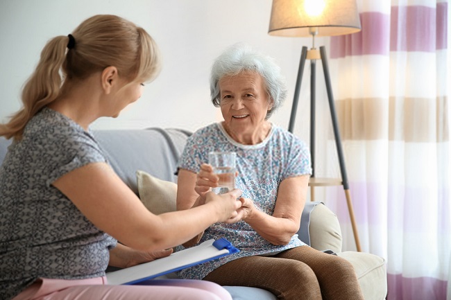 an elderly about to have a glass of water