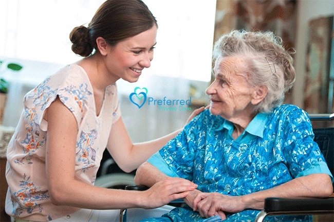 a woman and an elderly smiling at each other