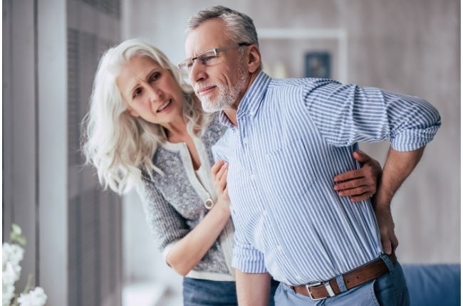 a man helped by his wife