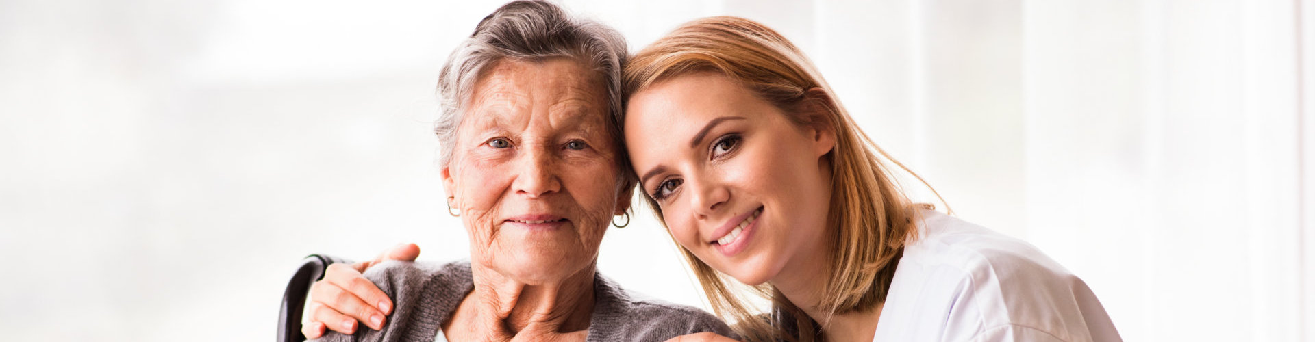 an old lady and a woman smiling