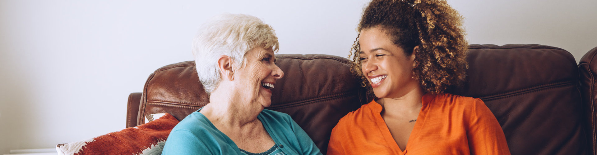 an old lady and a woman smiling at each other