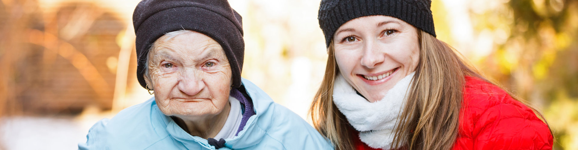 a woman and and old lady looking at the camera