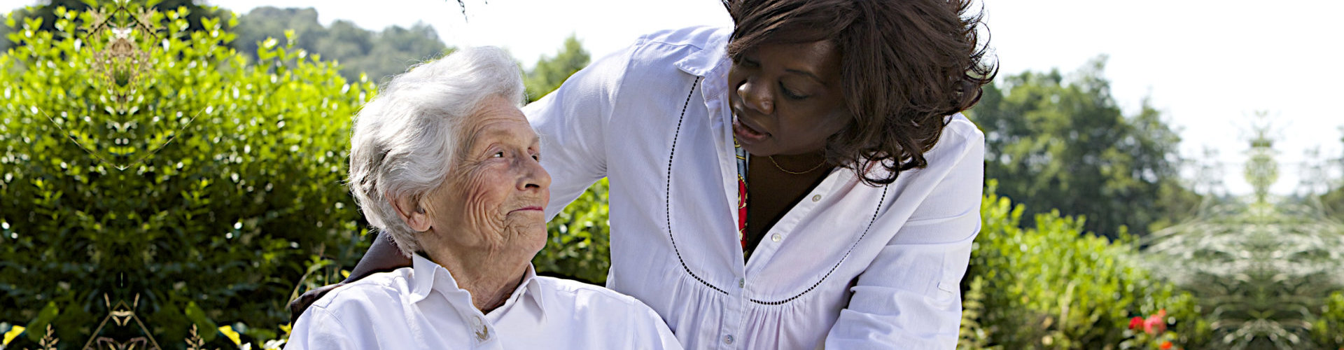 a senior on a wheel chair with a nurse