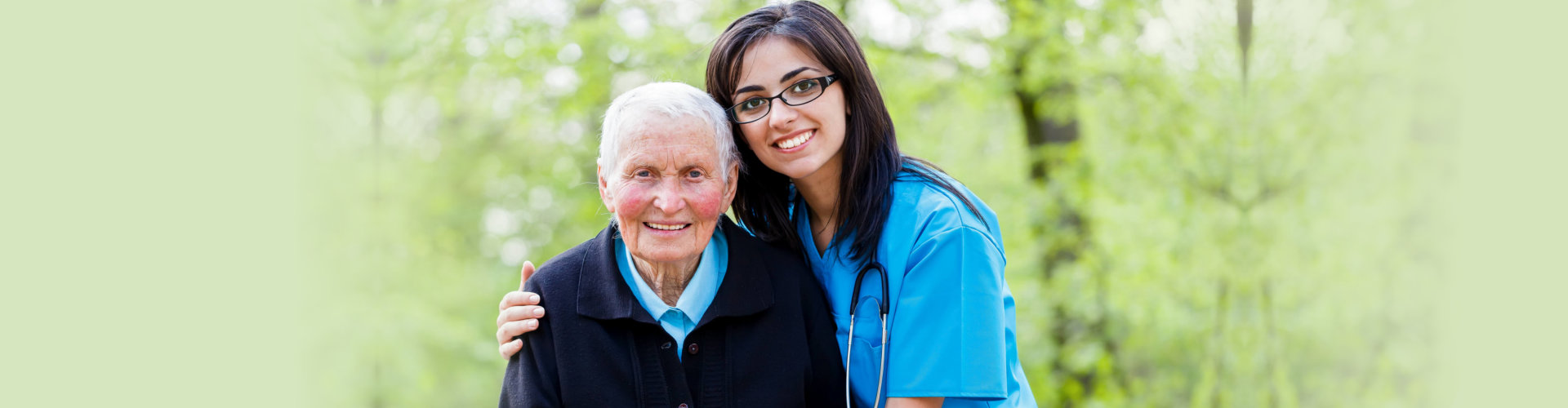 caregiver with elder woman outdoors