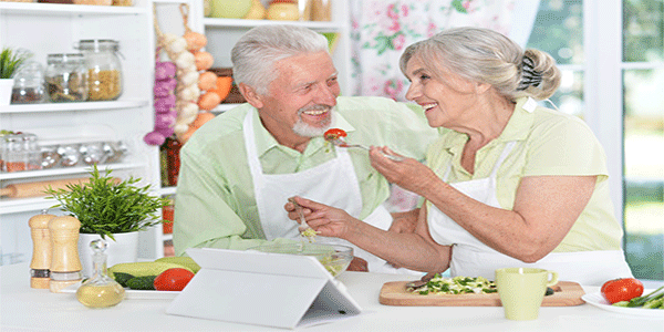 two seniors eating salad