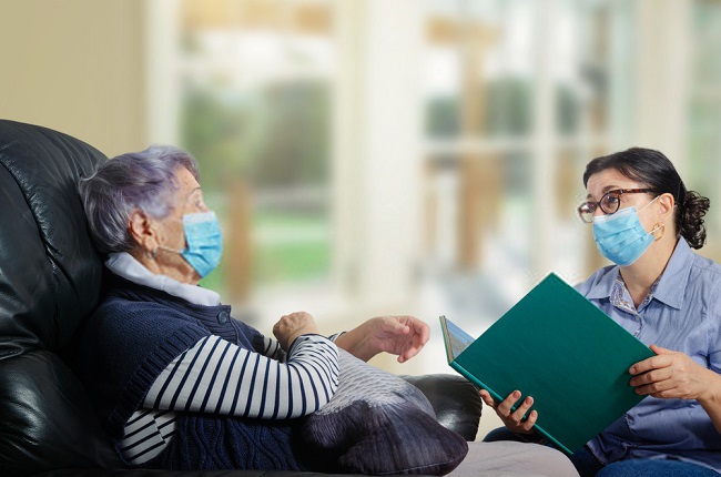 a nurse and an elderly wearing face masks