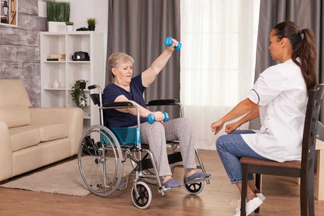 a woman guided by a nurse while exercising